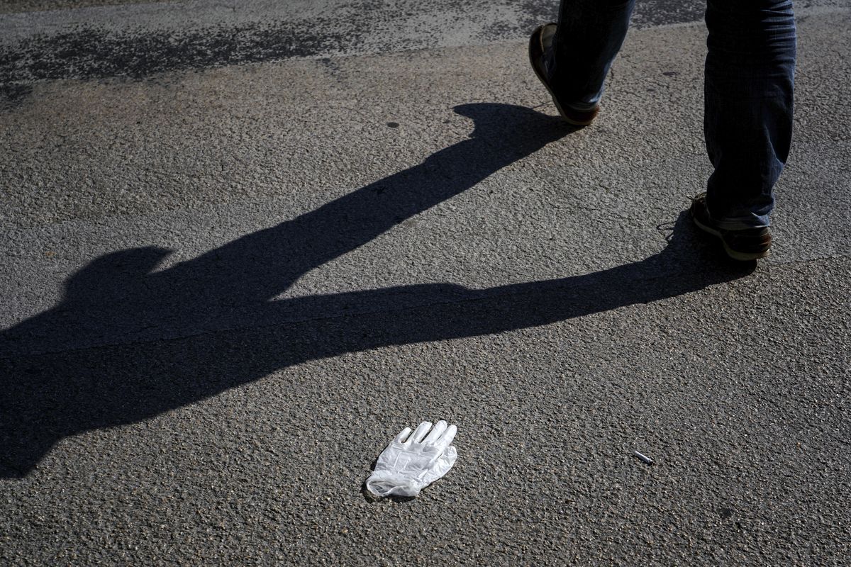A discarded protective glove rests on the street in Neuville sur Saone near Lyon, France, on April 9. (Laurent Cipriani / AP)