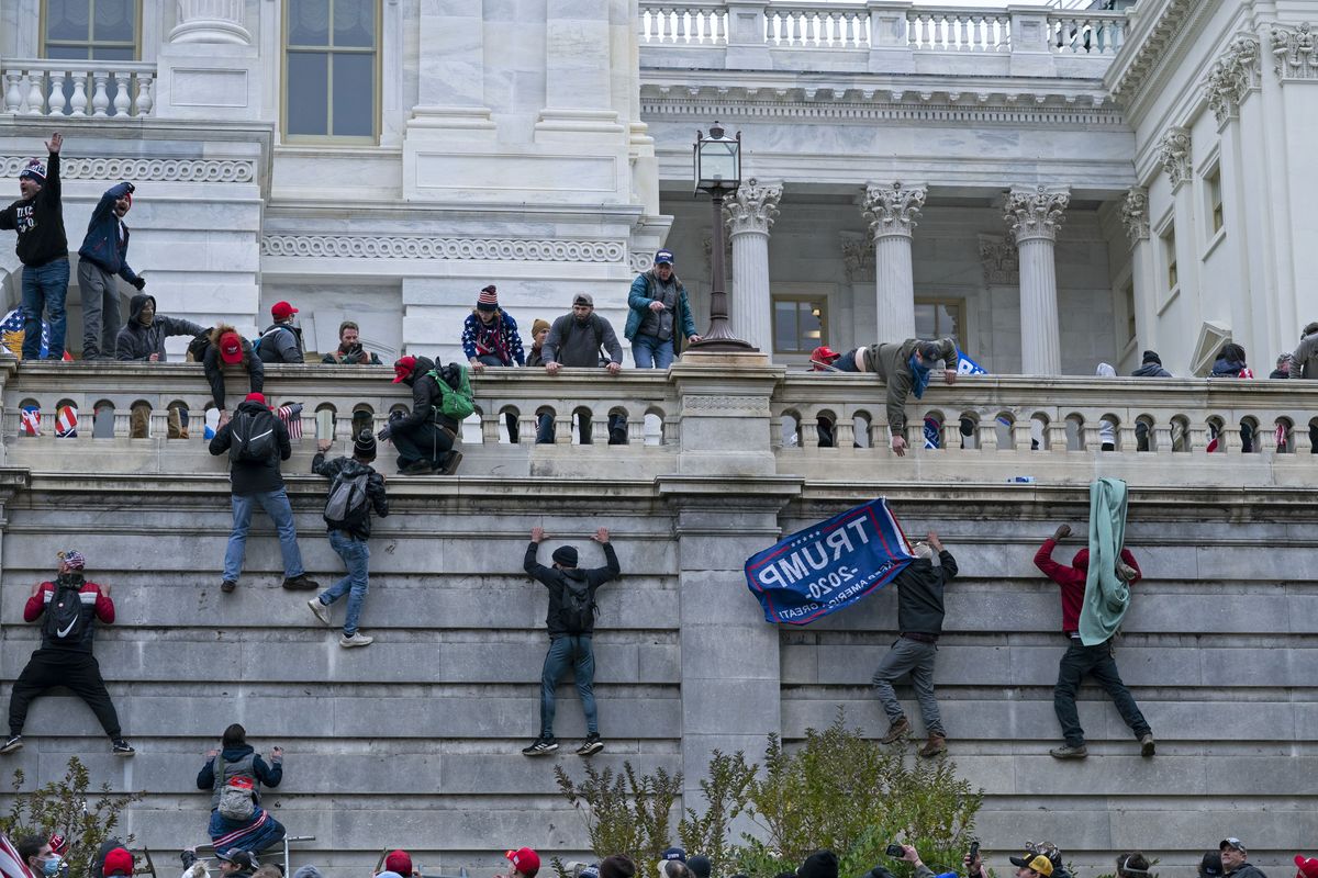 Rioters climb the west wall of the U.S. Capitol in Washington on Jan. 6. (Jose Luis Magana)