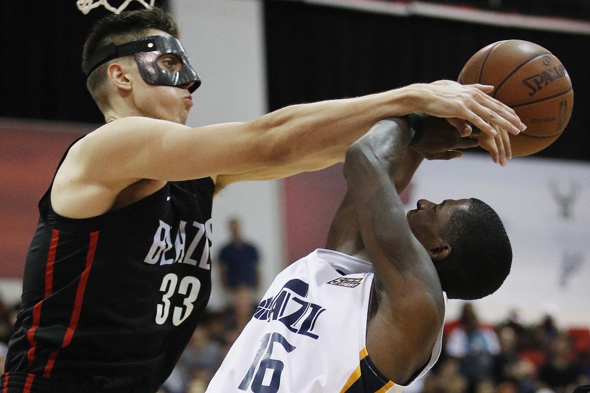 Portland’s Zach Collins blocks a shot by Utah’s Thomas Wilder during the second half of an NBA Summer League game on July 7 in Las Vegas. (John Locher / AP)