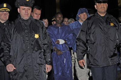 Police and FBI agents escort the Somali pirate suspect U.S. officials identified as Abduhl Wali-i-Musi into FBI headquarters.  (Associated Press / The Spokesman-Review)