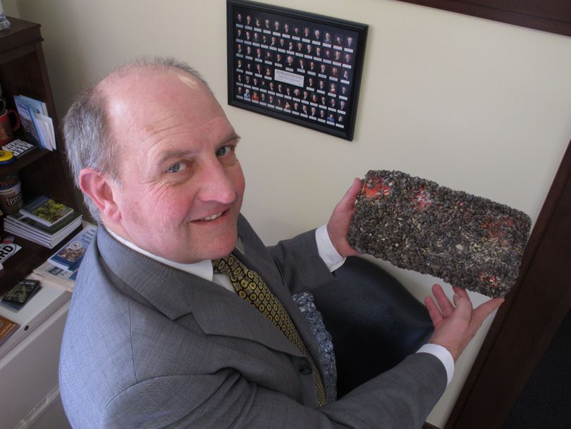 Idaho state Rep. Eric Anderson poses with an Idaho license plate he left for six months in Lake Mead to be encrusted with quagga mussels. (Associated Press)