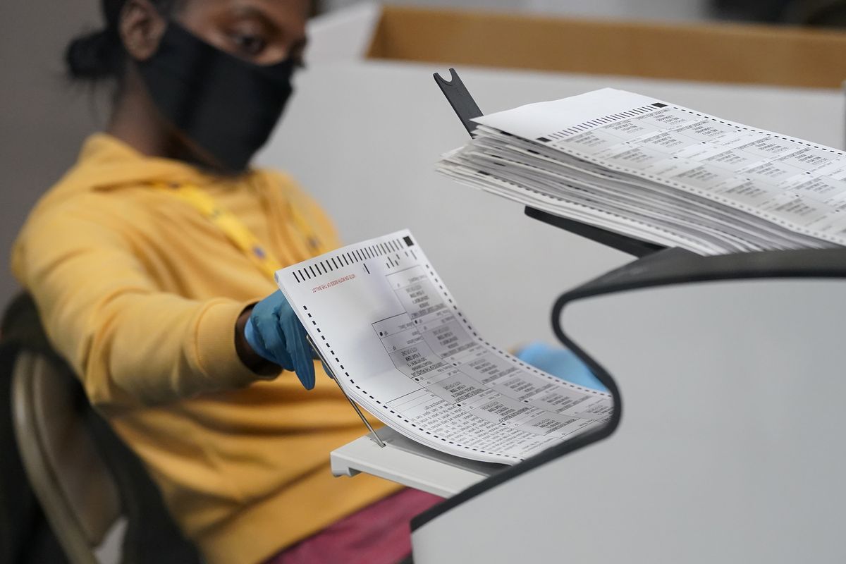 A county election worker scans mail-in ballots at a tabulating area Nov. 5, 2020, at the Clark County Election Department in Las Vegas.  (John Locher)