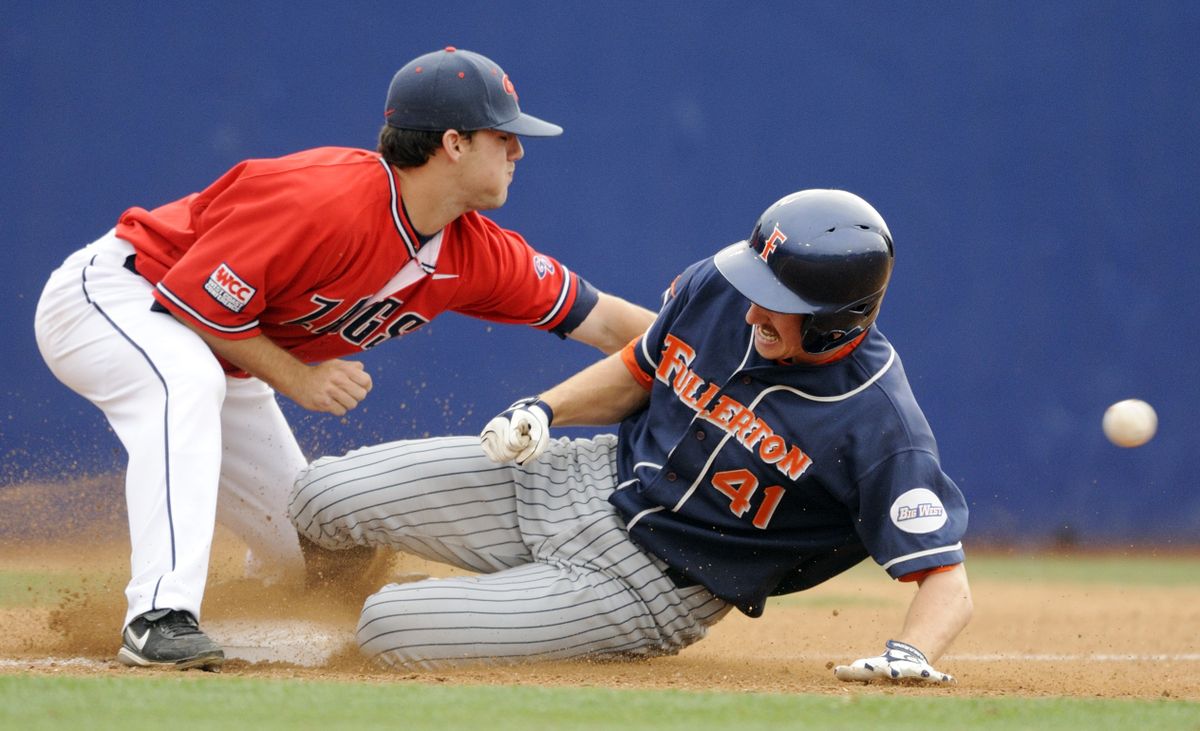 The Titans’ Joe Scott slides into third for a triple as the Zags’ Jason Chatwood waits for the throw. (Associated Press / The Spokesman-Review)