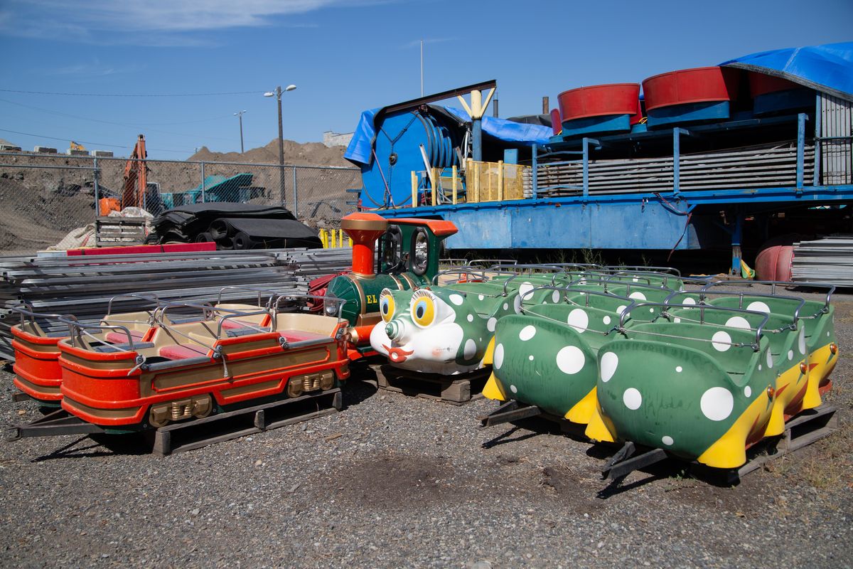 Rides including caterpillars, trains and a Tilt-a-Whirl are seen among others in the outdoor storage of the  maintenance facility. (Libby Kamrowski / The Spokesman-Review)