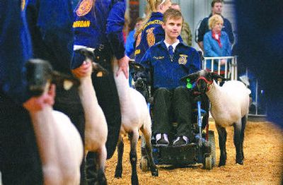 
Derek Turner and his lamb Secret line up with  other competitors for a last turn around the ring at the Junior Livestock Show  at the Spokane County Fair and Expo Center on Thursday. Turner won a blue ribbon in the competition. 
 (Christopher Anderson / The Spokesman-Review)
