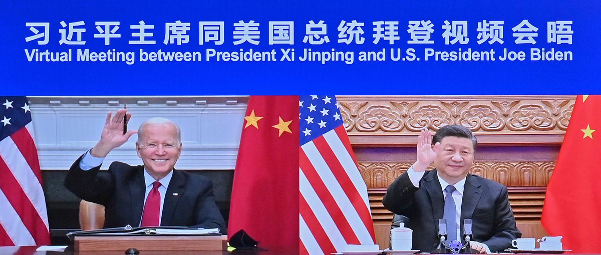 In this photo released by Xinhua News Agency Chinese President Xi Jinping, right and U.S. President Joe Biden appear on a screen as they hold a meeting via video link, in Beijing, China, Tuesday, Nov. 16, 2021. President Joe Biden opened his virtual meeting with China