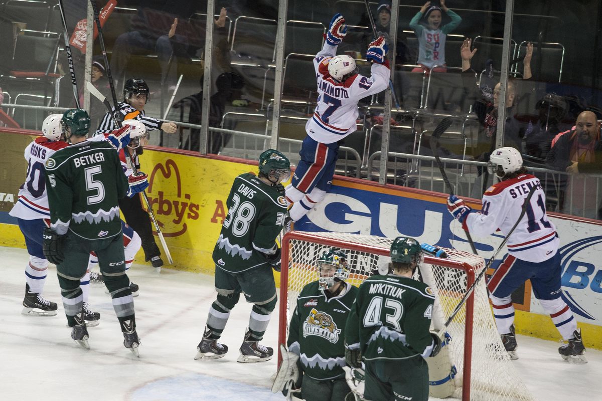 Spokane Chiefs center Kailer Yamamoto jumps on the glass after scoring the tying goal with 5 seconds left in the third period of Tuesday night’s game at the Arena.