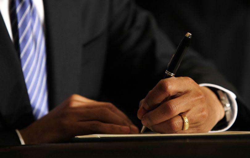 ORG XMIT: WHGH109 President Barack Obama signs an Executive Order on stem cells and a Presidential Memorandum on scientific integrity, Monday, March 9, 2009, in the East Room of the White House in Washington. (AP Photo/Gerald Herbert) (Gerald Herbert / The Spokesman-Review)