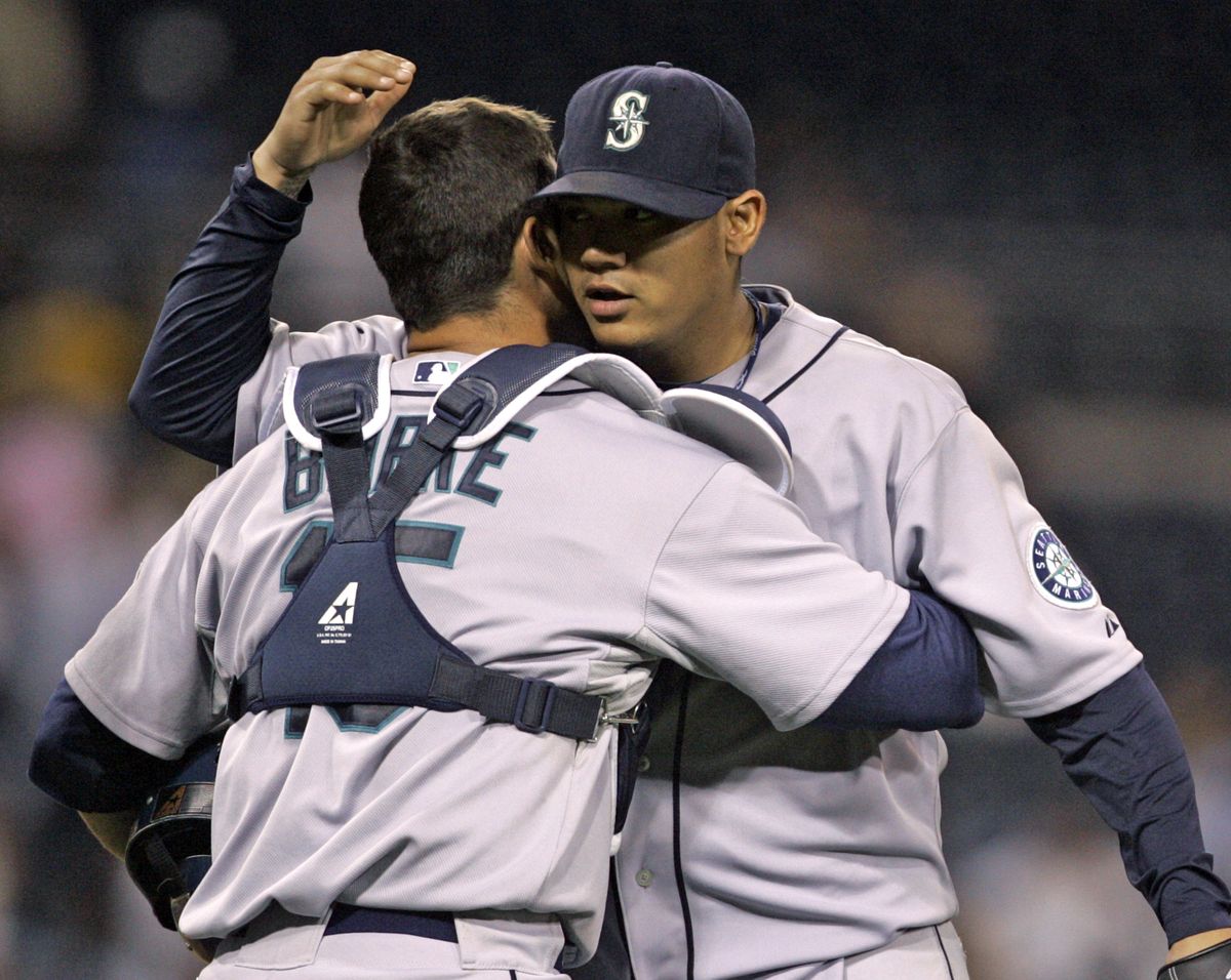 Felix Hernandez, right, is congratulated by catcher Jamie Burke after pitching his third career shutout. (Associated Press / The Spokesman-Review)