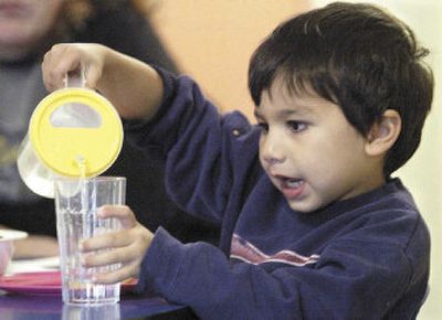 
Karun Winstein, 3, pours himself a glass of water during snack time at Turning Point Children's Enrichment and Developmental Center in Moscow, Idaho.
 (Moscow-Pullman Daily News / The Spokesman-Review)