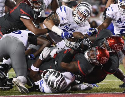 Houston running back Duke Catalon, bottom, falls into the end zone for a touchdown during the first half of an NCAA college football game against Memphis, Thursday, Oct. 19, 2017, in Houston. (Eric Christian Smith / Associated Press)