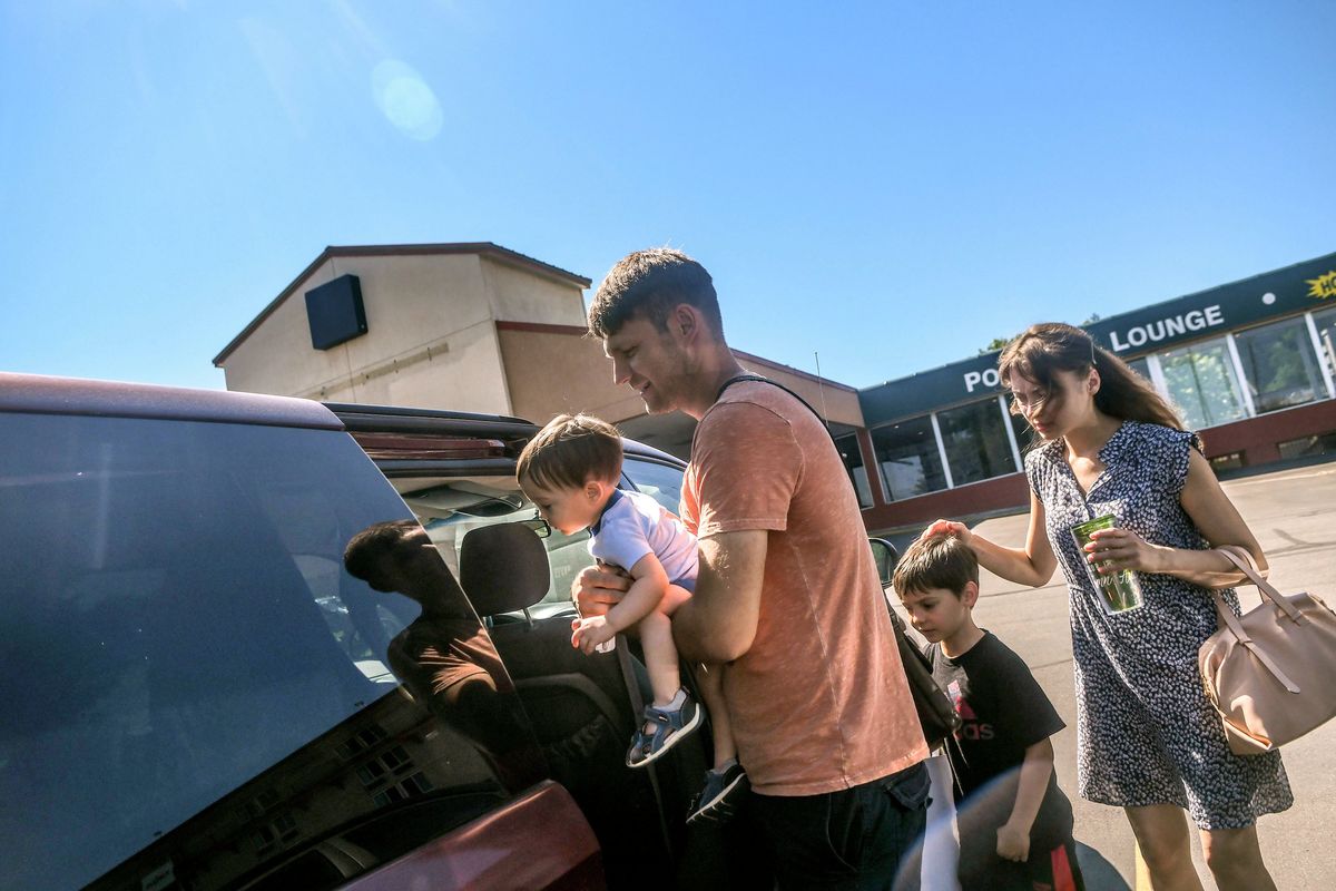 Mykhailo Kurilova loads his son Habriel, 1, into their borrowed van along with 6-year-old Yelysei and his wife, Anna, in 2022 at Thrive Center in Spokane.  (Kathy Plonka/THE SPOKESMAN-REVIEW)