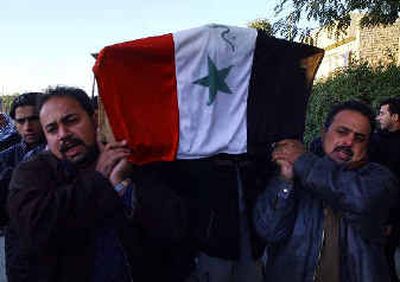 
Mourners carry the coffin of 20-year-old Iraqi policeman Ali Hashim, who was killed in Baghdad on Saturday. 
 (Associated Press / The Spokesman-Review)