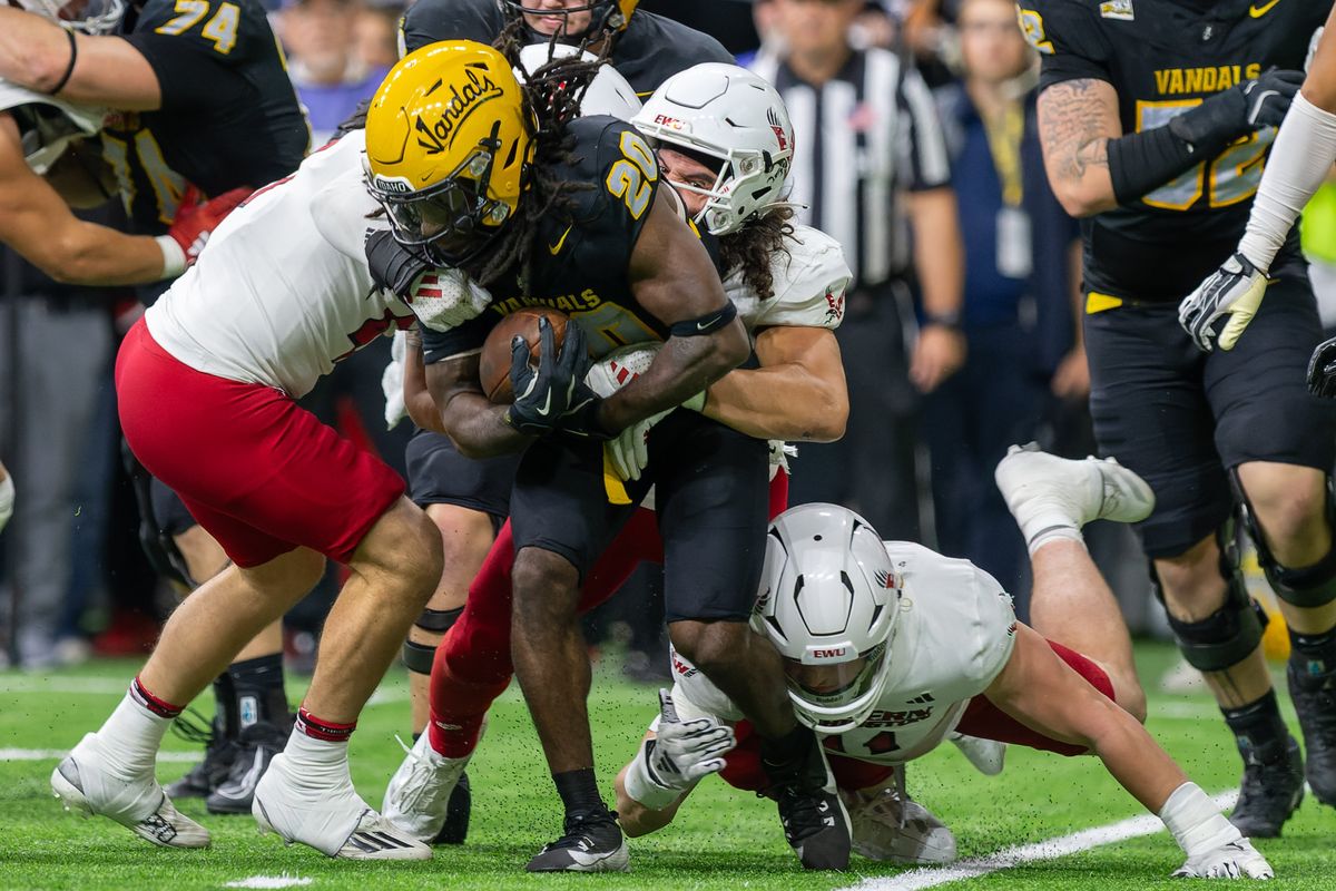 Idaho running back Elisha Cummings (20) is brought down by Eastern Washington defenders in the first half on Saturday, Oct. 26, 2024, at the Kibbie Dome in Moscow, Idaho  (Geoff Crimmins/For The Spokesman-Review)