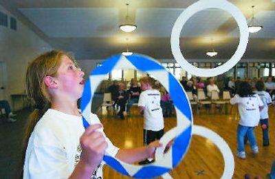 
Logan Parr of Lincoln Heights Elementary juggles  hoops at the Southside Senior Activity Center. 
 (CHRISTOPHER ANDERSON / The Spokesman-Review)