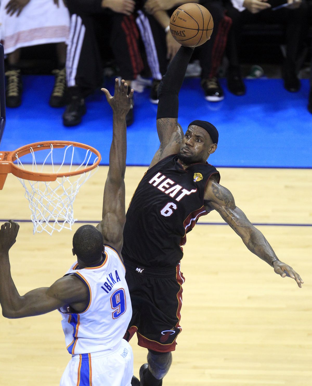 Heat’s LeBron James goes to the hoop over Thunder’s Serge Ibaka on his way to 32 points. (Associated Press)
