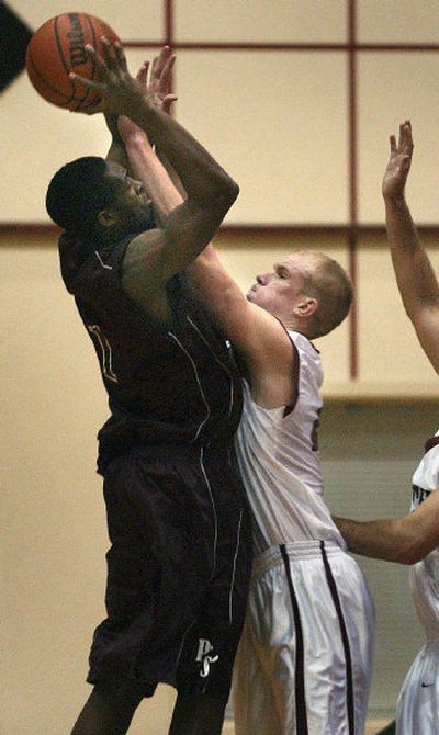 
Whitworth's Kevin Hasenfus, right, applies extreme pressure to Puget Sound's James Pinkney.
 (Brian Plonka / The Spokesman-Review)