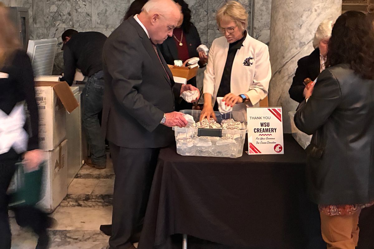 Washington State University President Betsy Cantwell passes out ice cream sandwiches on Wednesday in the halls of the legislative building.  (Lucille Stutesman / The Spokesman-Review)