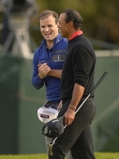 Zach Johnson, left, and Tiger Woods shake hands before going to playoff. (Associated Press)
