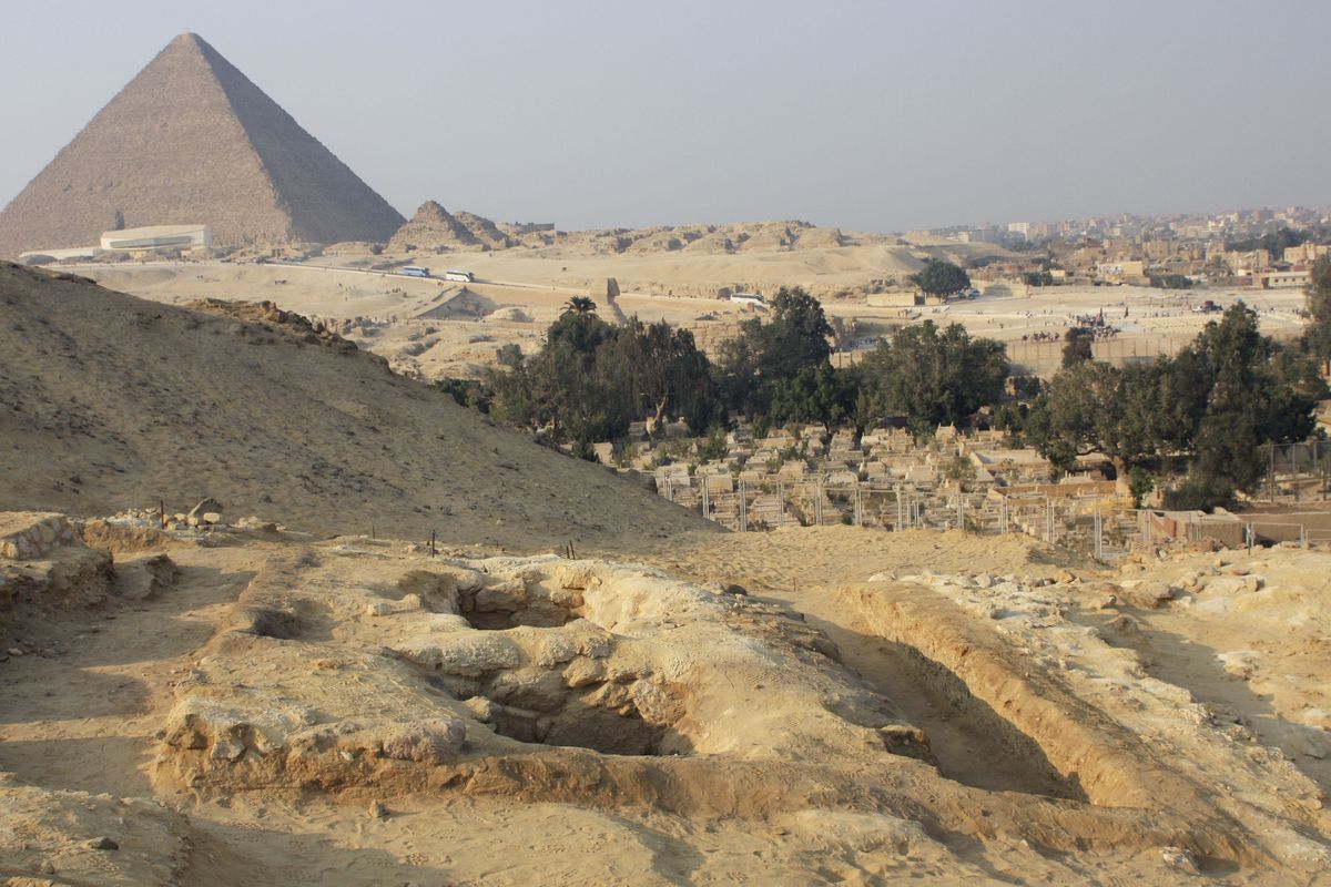 Newly discovered tombs of workers are seen, with the Great Pyramid in the background, in Giza, Egypt.