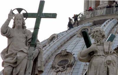 
A man identified as Rino Santilli is overpowered by Italian firefighters on the dome of St. Peter's Basilica Saturday at the Vatican. 
 (Associated Press / The Spokesman-Review)