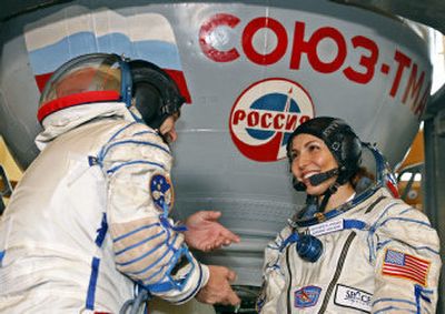 
U.S. entrepreneur Anousheh Ansari and Russian cosmonaut Mikhail Tyurin share a joke before  their final preflight practical examination Aug. 24 at the Russian Space Training Center outside Moscow. 
 (Associated Press / The Spokesman-Review)