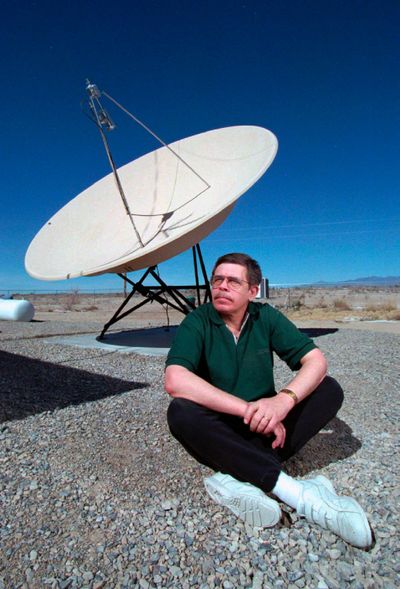 Late night talk show host Art Bell is shown March 7, 1997, near a satellite dish at his Pahrump, Nev., home. (Aaron Mayes / Las Vegas Sun)