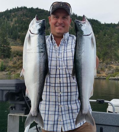 Fishing guide Troy Black holds a pair of huge Lake Roosevelt kokanee. (Courtesy)