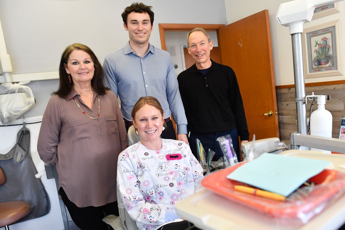 Whittaker Family Dentistry, from left, office manger Marsha Whittaker, Dr. Dan Whittaker, Dr. Earl Whittaker and Stephanie Berend, foreground, pose for a photo Tuesday at their clinic in Spokane.  (Tyler Tjomsland/The Spokesman-Review)