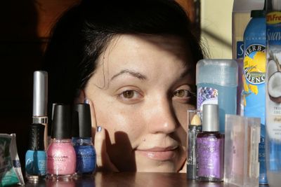 Jesse Chapman, of Kansas City, posing with her many of her personal care products, has agreed to take the challenge to try to use healthier, more eco-friendly products. McClatchy-Tribune (McClatchy-Tribune / The Spokesman-Review)