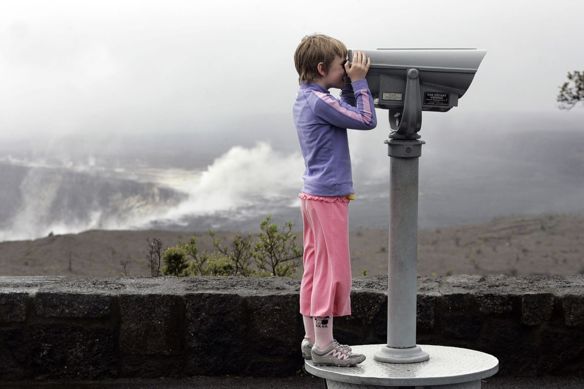 A child views the surrounding area of the Halemaumau Crater near the Jaggar Museum at Hawaii Volcanoes National Park in Volcano, Hawaii, in March 2008.  (Associated Press / The Spokesman-Review)