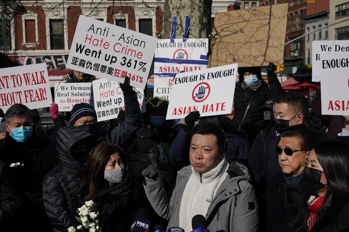 People hold signs during a rally in response to the killing of Christina Yuna Lee in the Chinatown section of New York, Monday, Feb. 14, 2022. Lee was stabbed to death inside her lower Manhattan apartment by a man who followed her from the street into her building, authorities said. (Seth Wenig)
