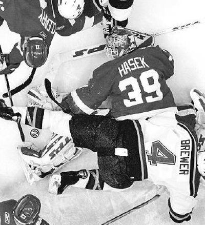 
Detroit Red Wings goalie Dominik Hasek searches for the puck Friday. 
 (Associated Press / The Spokesman-Review)