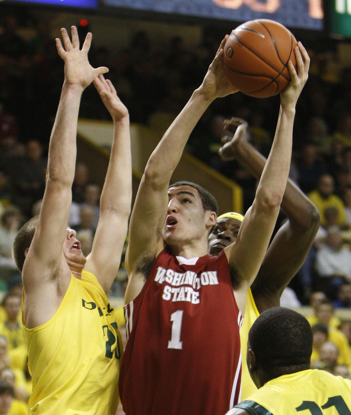 Cougars’ Klay Thompson, center, goes to the basket in the first half. (Associated Press)