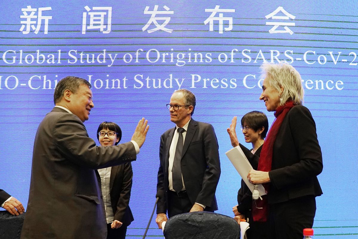 Marion Koopmans, right, and Peter Ben Embarek, center, of the World Health Organization team say farewell to their Chinese counterpart Liang Wannian, left, after a WHO-China Joint Study Press Conference held at the end of the WHO mission in Wuhan, China, Tuesday, Feb. 9, 2021.  (Ng Han Guan)