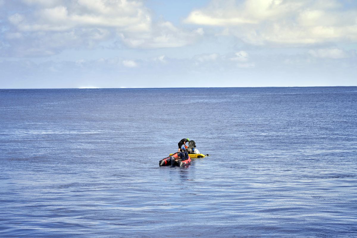 A small boat carrying Stephanie Marie, a young scientist from the Seychelles, reaches a submersible for a technical test dive near the tiny Alphonse atoll, on Friday 8 March, 2019. A young scientist from the Seychelles has become the first known Seychellois to explore deep below scuba depth in the largely uncharted waters of her island nation. 23-year-old Stephanie Marie was offered a seat in a submersible for a technical test dive near the tiny Alphonse atoll on International Womens Day. The marine researcher is taking part in the Nekton Mission to explore the Indian Ocean, one of the last major unexplored frontiers. (David Keyton / Associated Press)