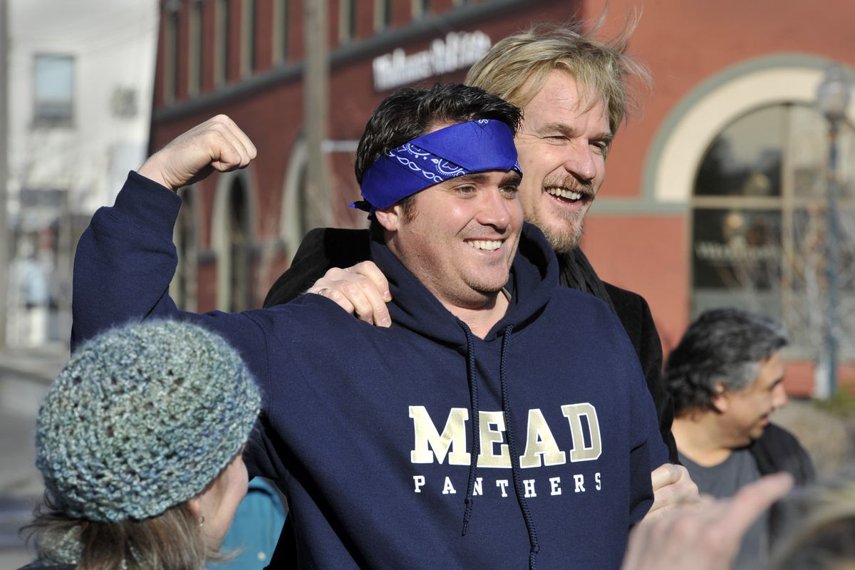 Dressed as a wrestler, Tom Flanigan, 38, of Spokane, shows a little muscle as he poses for a picture with movie and TV actor Matthew Modine during a gathering Friday in Riverfront Park. Dozens gathered to “run the bridges just like Louden Swain,” Modine’s character in the Spokane-filmed 1985 movie “Vision Quest.” (Dan Pelle)