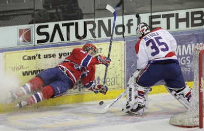 Lethbridge goalie Juha Metsola beats airborne Spokane Chief Justin McCrae to the puck to clear it during Wednesday's 4-1 Spokane win. For
(Photos by David Rossiter For / The Spokesman-Review)