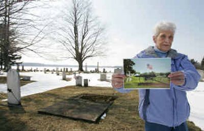 
Joette Knapp, Kendall town historian, holds a photo Thursday that she made of the Civil War cannon that was recently sold and removed from Greenwood Cemetery in Kendall, N.Y.
 (Associated Press / The Spokesman-Review)