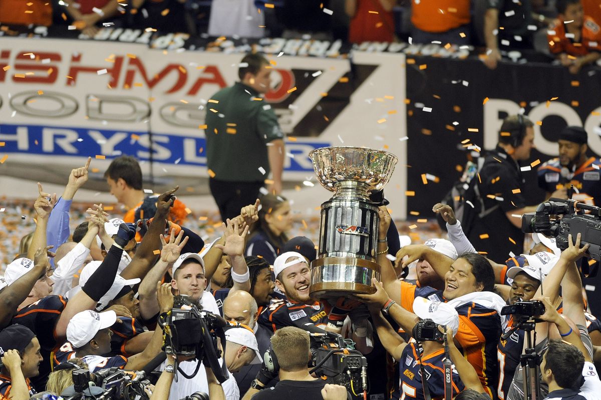 Spokane Shock players celebrate their win over the Tampa Bay Storm and hoist the ArenaBowl trophy at the Spokane Arena on Friday night. (Christopher Anderson)