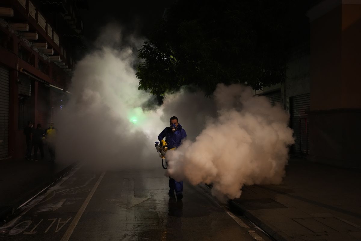 In this July 1, 2021, file photo, a worker in personal protective equipment sanitizes a street in the wake of a spike in the number of positive coronavirus cases, in downtown Guatemala City. The global death toll from COVID-19 has eclipsed 4 million as the crisis increasingly becomes a race between the vaccine and the highly contagious delta variant. (Associated Press)
