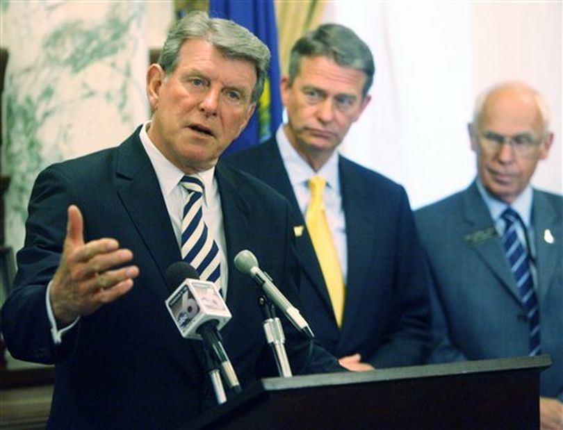 Gov. Butch Otter discusses Idaho's budget situation at the fiscal year-end, at a press conference in his office on July 13. At center is Lt. Gov. Brad Little, and at right, Rep. Darrell Bolz, R-Caldwell. (AP Photo / The Idaho Statesman, Shawn Raecke)