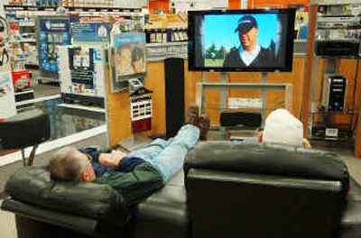 Potential high-end television customers relax as they watch a flat panel plasma model at the Best Buy Store last month in Maple Grove, Minn. Retailers, including Best Buy, expect sales for flat panel televisions to double from last year.
(Associated Press / The Spokesman-Review)