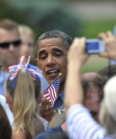 President Barack Obama takes a flag from Katelyn Maloy, 5, in Sandusky, Ohio, on Thursday, during his two-day bus trip through Ohio and Pennsylvania. (Associated Press)