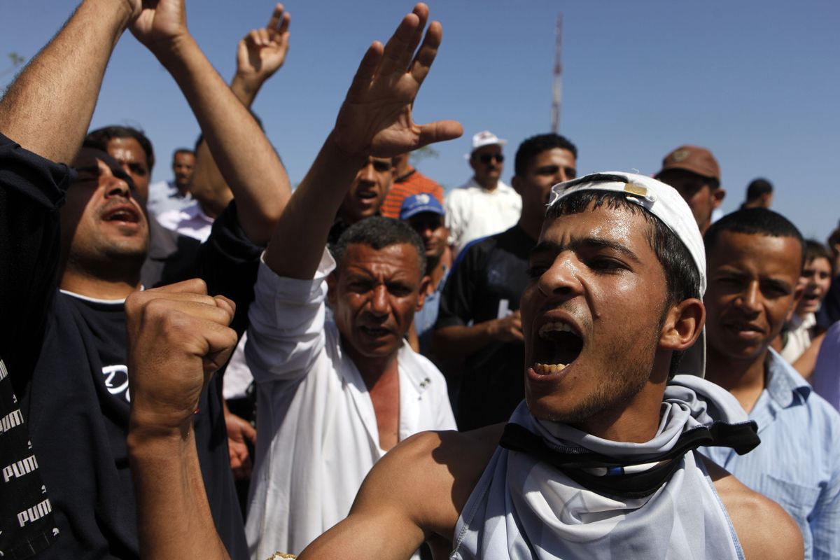 Egyptians shout anti-Mubarak slogans Wednesday in front of the hospital where the former leader is being held. (Associated Press)