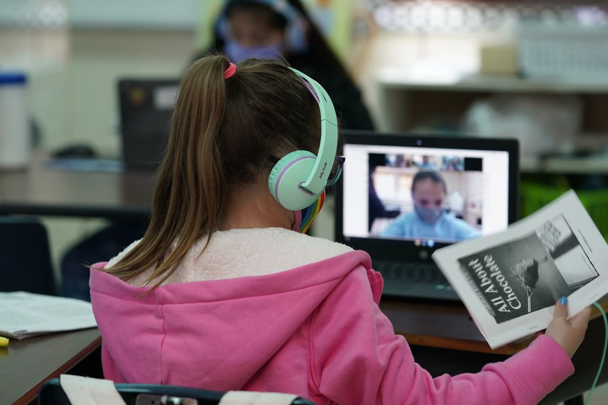 Students at Driggers Elementary School attend a class in-person as they interact with classmates virtually, Monday, Feb. 8, 2021, in San Antonio. After seeing two academic years thrown off course by the pandemic, school leaders around the country are planning for the possibility of more distance learning next fall at the start of yet another school year.  (Eric Gay)