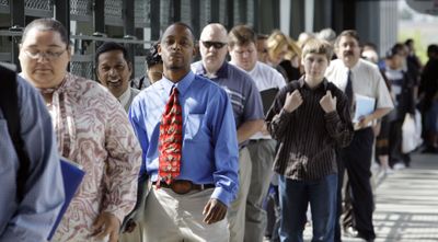 People wait in line to enter a job fair Tuesday in Seattle. Washington’s unemployment rate rose to 9.4 percent in May, up from a revised rate of 9 percent in April. (Associated Press / The Spokesman-Review)