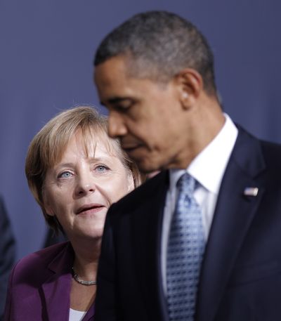 German Chancellor Angela Merkel looks at U.S. President Barack Obama at the  NATO summit in Lisbon, Portugal, on Friday.  (Associated Press)