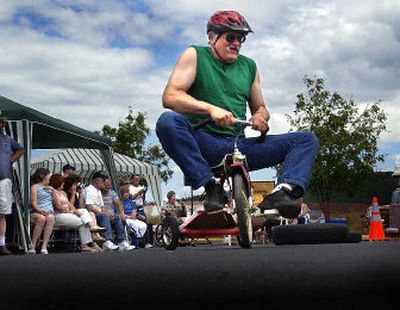 
Marty Phanco struggles with his racing trike while the rest of the crowd watches the front runners during the 2004 Skytona 500. The Big Sky Tavern will hold the fifth annual trike races on Saturday as a benefit for the American Cancer Society.
 (photo archive / The Spokesman-Review)