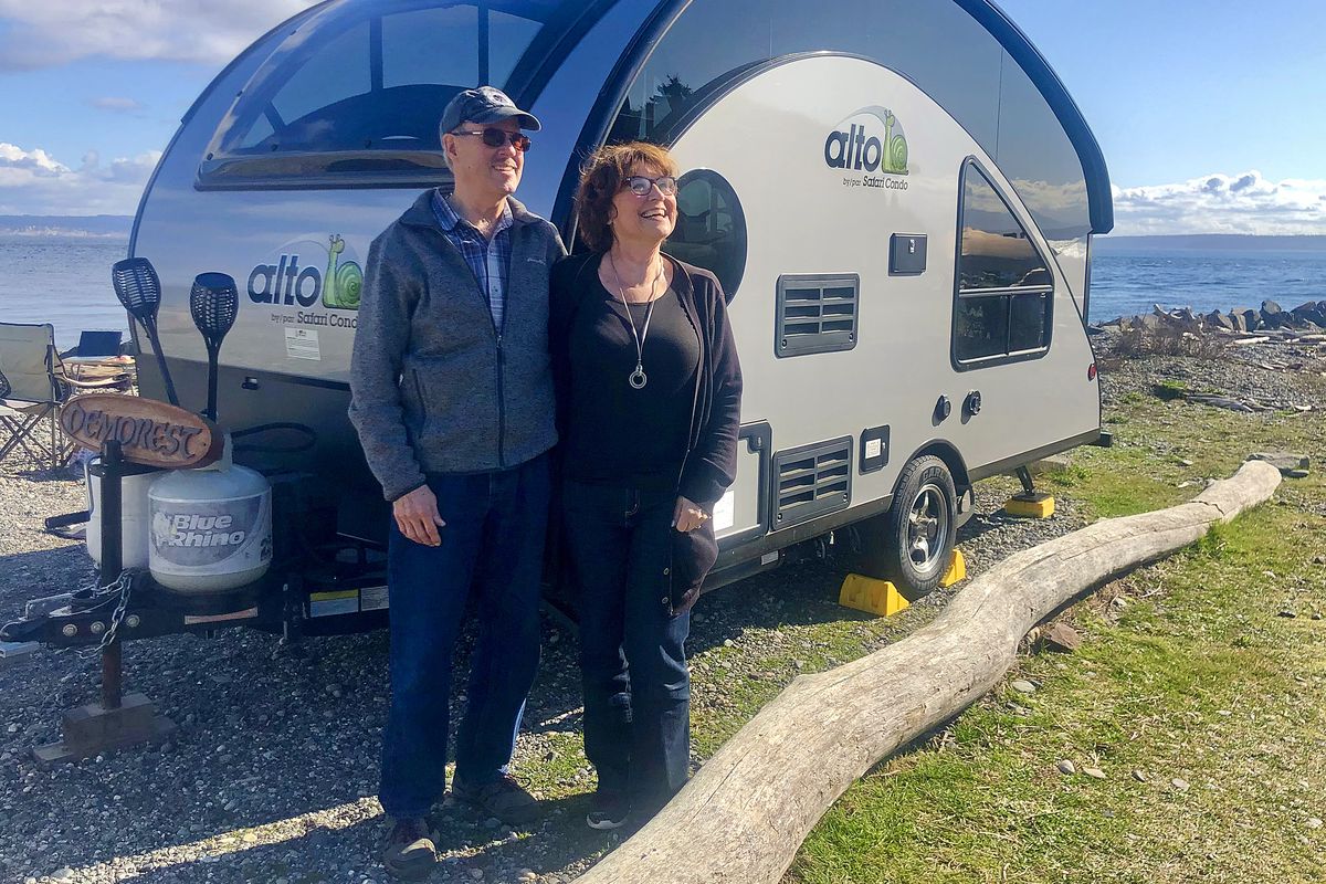 Barb and Denny Demorest of Bellingham stand beside their Alto by Safari Condo, a small travel trailer at Fort Casey State Park on Whidbey Island. (Leslie Kelly)